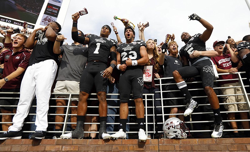 Mississippi State players and fans celebrate following their 35-28 win over No. 7 Texas A&M in an NCAA college football game in Starkville, Miss., Saturday, Nov. 5, 2016. (AP Photo/Rogelio V. Solis)