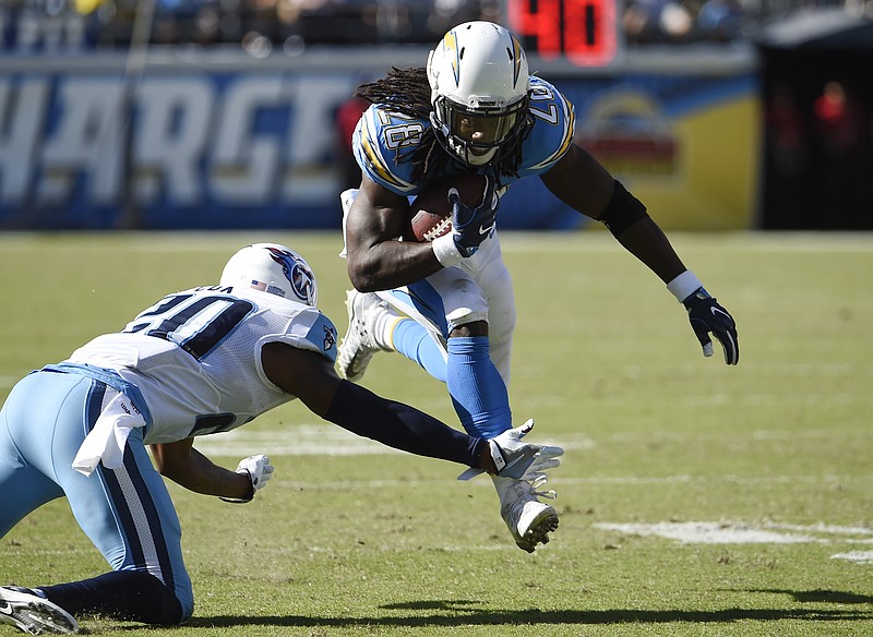 San Diego Chargers running back Melvin Gordon (28) runs with the ball as Tennessee Titans cornerback Perrish Cox defends during the first half of an NFL football game, Sunday, Nov. 6, 2016, in San Diego. (AP Photo/Denis Poroy)