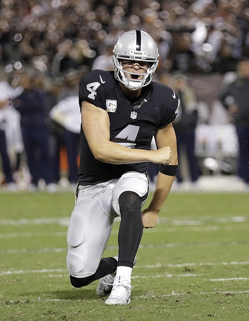 
              Oakland Raiders quarterback Derek Carr (4) celebrates after Latavius Murray ran for a touchdown against the Denver Broncos during the first half of an NFL football game in Oakland, Calif., Sunday, Nov. 6, 2016. (AP Photo/Marcio Jose Sanchez)
            