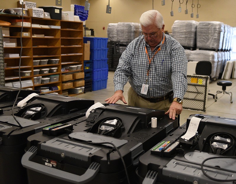 Bill Adams sets up the machines Monday, Nov. 7, 2016, at the Hamilton County Election Commission that will count absentee ballots after they are verified.