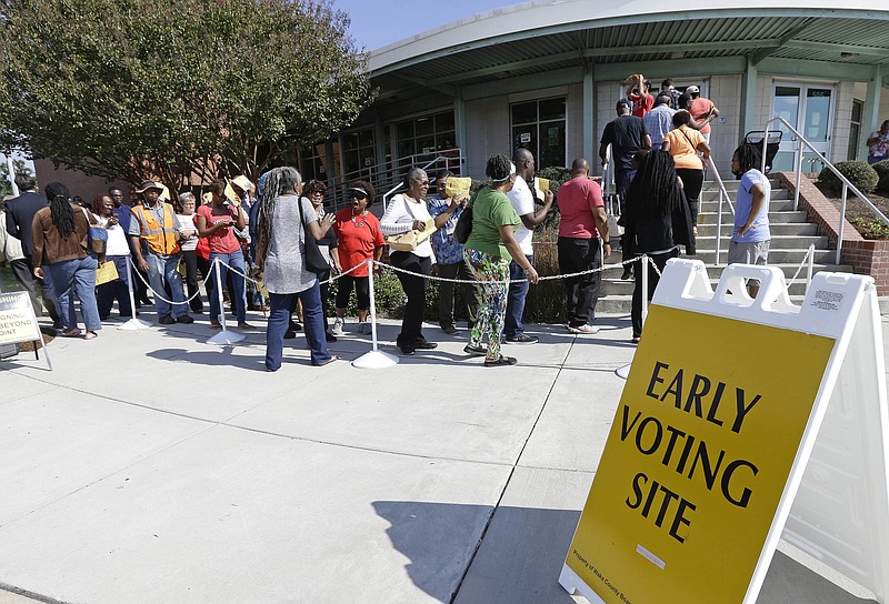 
              FILE - In this Oct. 20, 2016 file photo ,voters line up during early voting at Chavis Community Center in Raleigh, N.C. More than a dozen states have enacted tougher requirements for registering and voting since the U.S. Supreme Court overturned a key provision of the Voting Rights Act three years ago. That has led to confusion and claims that certain groups, mostly minorities who tend to vote with Democrats, are being disenfranchised. (AP Photo/Gerry Broome, File)
            