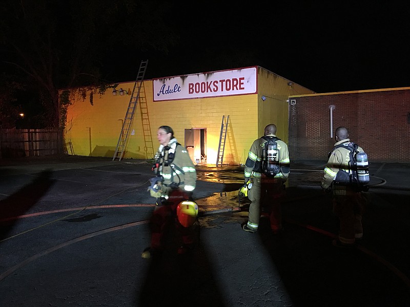 Firefighters emerge after responding to a fire at an adult cinema located in the 4100 block of Rossville Boulevard.