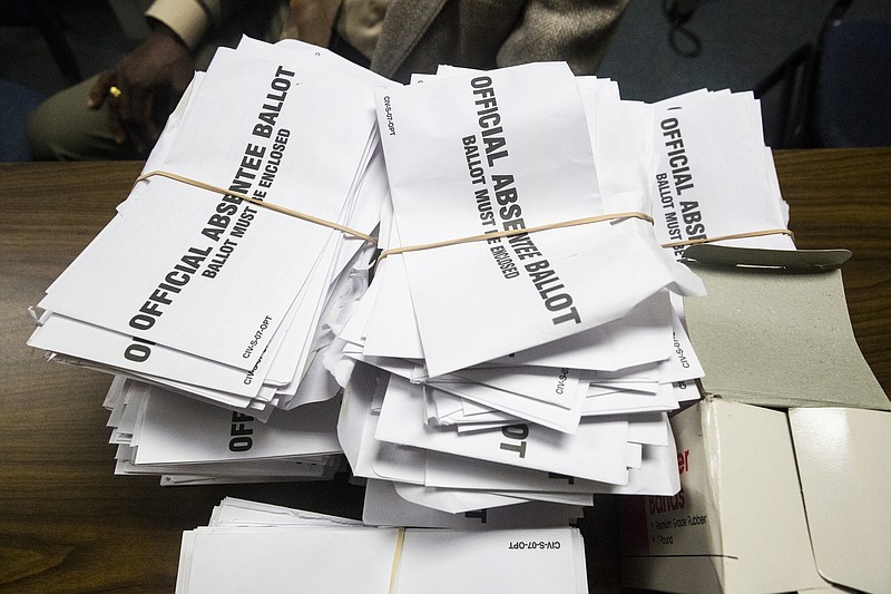 Absentee ballots are stacked for counting at the Walker County Courthouse on Tuesday, Nov. 8, 2016, in Lafayette, Ga.