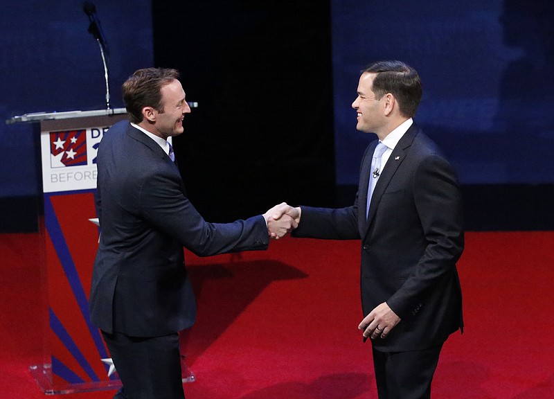 In this Oct. 26, 2016, file photo, Rep. Patrick Murphy, left, and Sen. Marco Rubio shake hands before the start of a debate at Broward College in Davie, Fla.