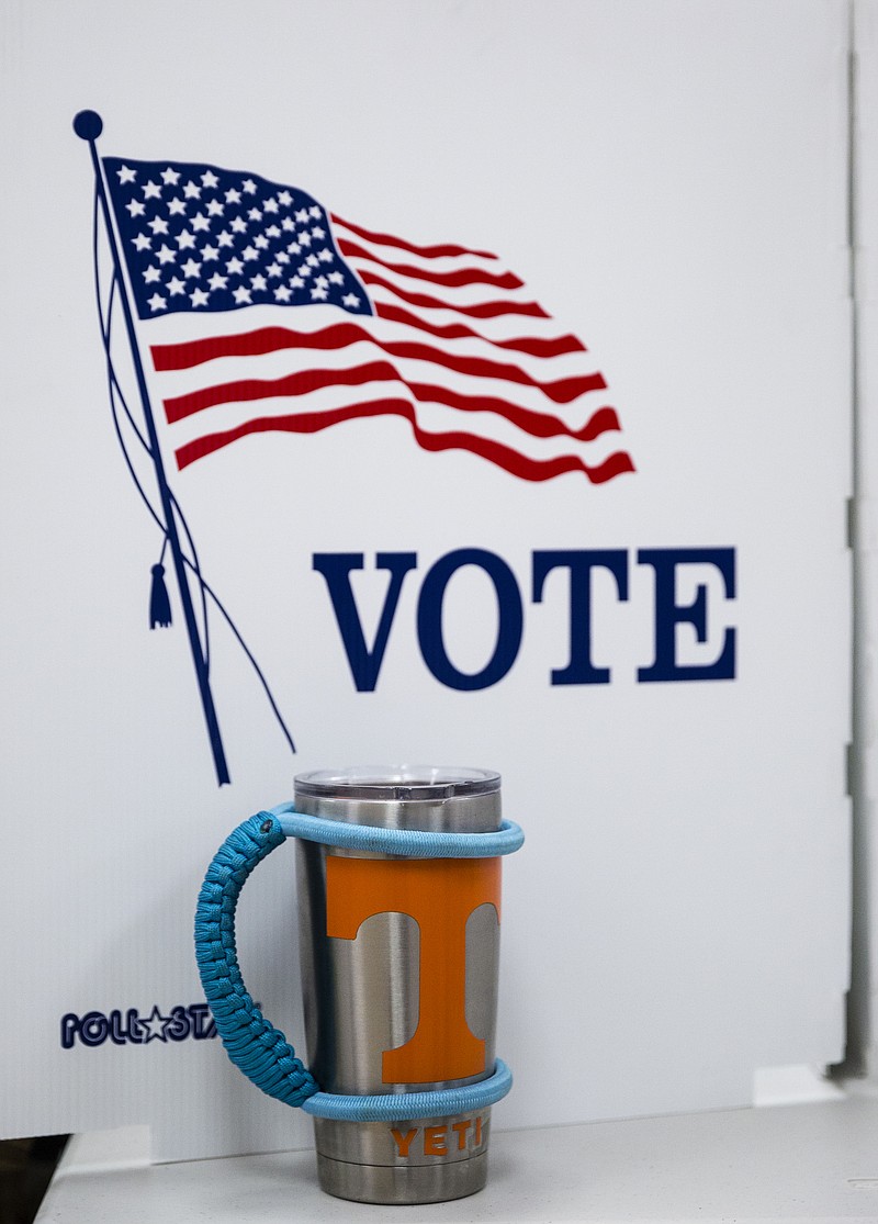 A University of Tennessee mug sits by a voting booth as a voter casts their ballot during early voting at the Hamilton County Election Commission on Amnicola Highway on Saturday, Oct. 22, 2016, in Chattanooga, Tenn.