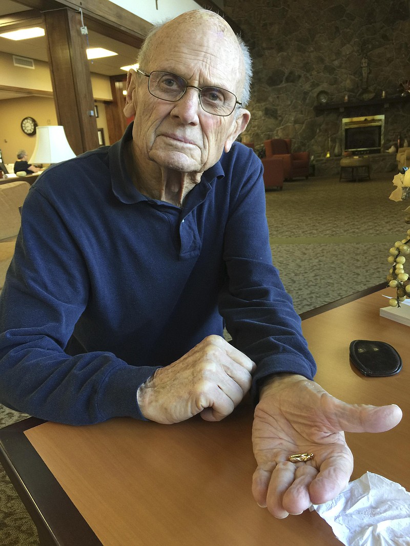 Bud Crevasse shows the pendant he found. Its rightful owner was found and the pendant was returned. It contains cremation ashes of the owner's husband. 