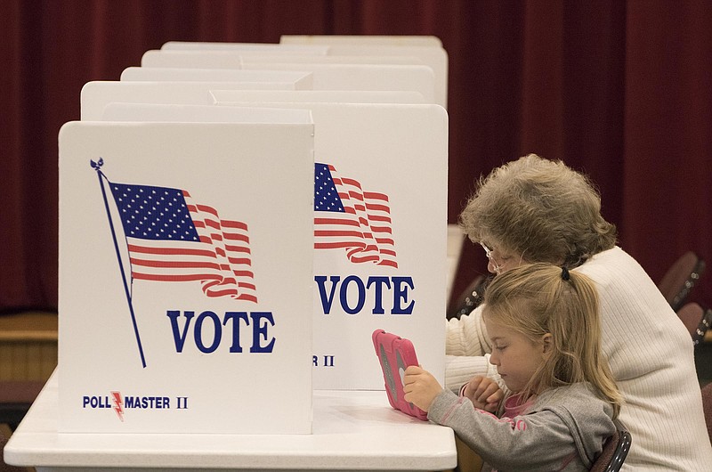 Four-year-old Kadence Cagle waits as her great-great grandmother Elizabeth Conway votes on Nov. 8, 2016, at the Hixson Fellowship Hall in Red Bank Cumberland Presbyterian Church. 