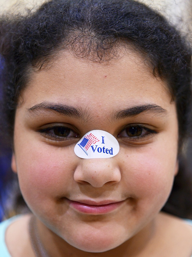 
              Adriana Palek wears her mother's "I Voted" sticker on her nose after her mother voted on Election Day at the Jewish Community Center in Utica, N.Y., Tuesday, Nov. 8, 2016. (Tina Russell/Observer-Dispatch via AP)
            