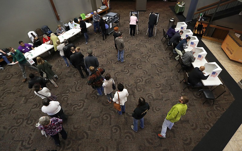 
              FILE - In this Nov. 8, 2016 file photo, local residents stand in line to receive their ballots before voting in the general election at the First Church of the Open Bible in Des Moines, Iowa. A fractured, discontented electorate handed Donald Trump the presidency, allowing him to breach a region that Democrat Hillary Clinton was banking on in her bid for the presidency. (AP Photo/Charlie Neibergall, File)
            