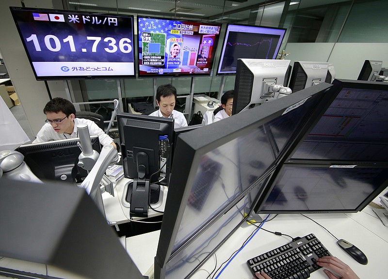 Money traders watch computer screens with the day's exchange rate between Japanese yen and the U.S. dollar at a foreign exchange brokerage in Tokyo, Wednesday, Nov. 9, 2016. 