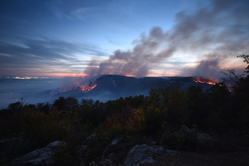 Two major fires burn at the Flipper Bend forest fire atop Walden Ridge in this view to the southwest from Montlake. The lights on the horizon, at left, is the Northgate Mall portion of Hixson. Crews from Tennessee State Parks, the Tennessee Department of Agriculture Forestry Division and U.S. Forestry Service personnel from the Bureau of Land Management were on scene as two Air National Guard BlackHawk helicopters sporadically dumped water on the expanding blaze.