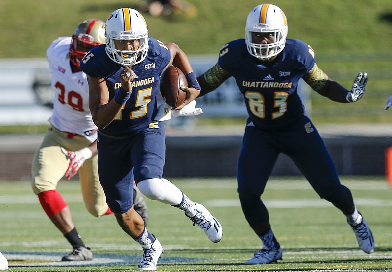 UTC quarterback Alejandro Bennifield breaks away from VMI linebacker Alijah Robinson, left, and teammate Malcolm Colvin during the Mocs' home football game against the VMI Keydets at Finely Stadium on Saturday, Oct. 22, 2016, in Chattanooga, Tenn.