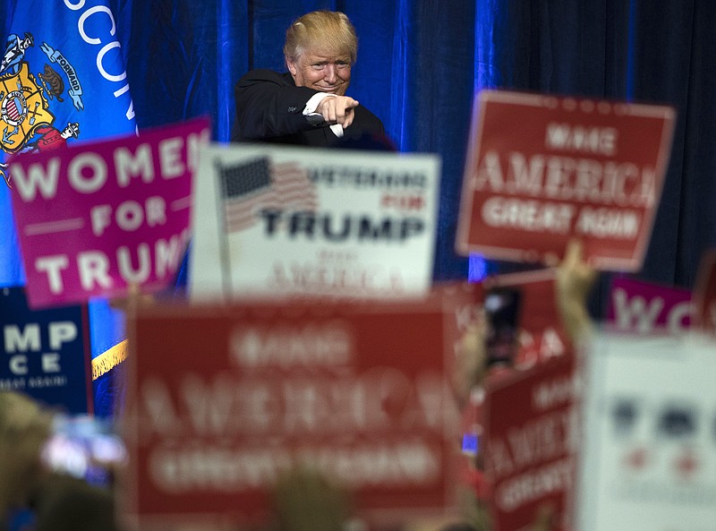 
              FILE - In this Tuesday, Nov. 1, 2016, Republican presidential candidate Donald Trump gestures during a campaign state at the University of Wisconsin-Eau Claire in Eau Claire, Wis. In his victory speech, Trump called them America’s “forgotten men and women”,  the workers from the coalfields of Appalachia to the hallowing manufacturing towns of the Rust Belt who propelled him to an improbable victory. They felt left behind by progress, laughed at by the elite, and so put their faith in the billionaire businessman with a sharp tongue and short temper. (AP Photo/Matt Rourke, File)
            