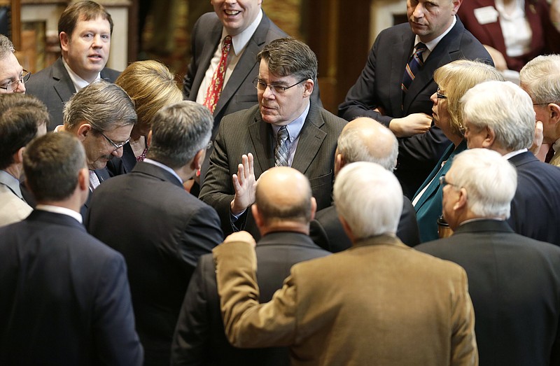 
              FILE- In this May 2, 2014, file photo, Iowa Senate Majority Leader Michael Gronstal, center, talks to fellow Senate Democrats on the floor of the Senate at the Statehouse in Des Moines, Iowa. Gronstal, a powerful Democrat who had been a fixture in state government for three decades, lost to Republican Dan Dawson, of Council Bluffs, in the Tuesday, Nov. 8, 2016 election. (AP Photo/Charlie Neibergall, File)
            