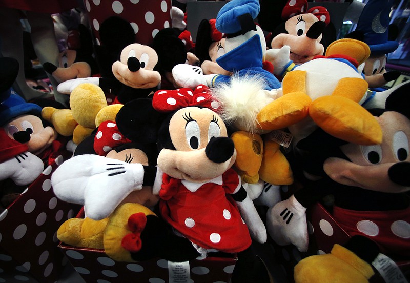 
              FILE - This Jan. 31, 2014, file photo shows plush Disney characters piled up in a display at a Disney Store in Saugus, Mass. As more and more people get their favorite TV shows and movies online, Disney is also learning to embrace the stream. The company once resisted offering channels like ESPN directly over the internet, preferring old-fashioned cable subscriptions. But Disney, which owns Marvel, Star Wars and its own Pixar and Disney Studios, is forging ahead with new streaming deals involving Netflix, Hulu and others. (AP Photo/Elise Amendola, File)
            