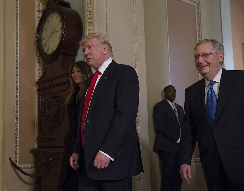 
              President-elect Donald Trump and his wife Melania walks with Senate Majority Leader Mitch McConnell of Ky. on Capitol Hill in Washington, Thursday, Nov. 10, 2016, after their meeting.  (AP Photo/Molly Riley)
            