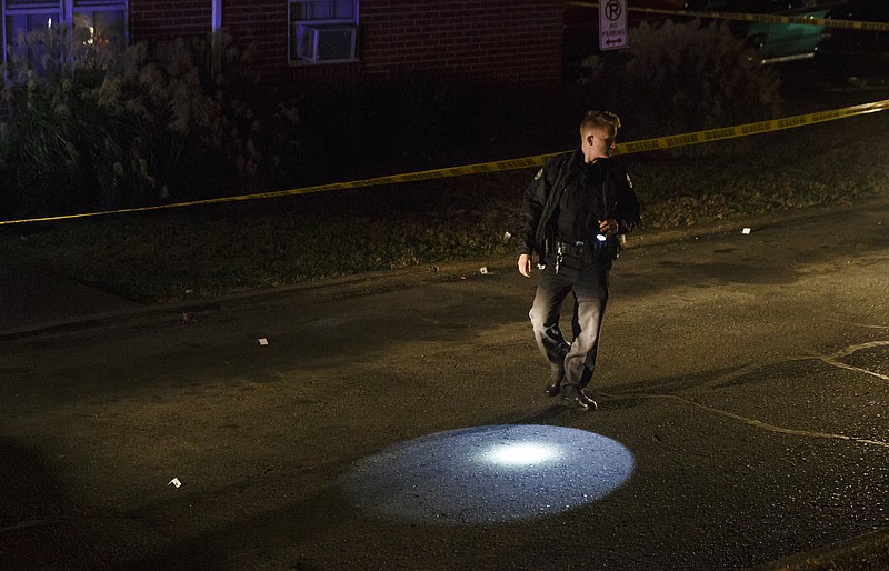 A Chattanooga police officer works the scene of a shooting at The Pinewood apartments on Pinewood Avenue that sent one victim to the hospital early in the evening Thursday, Nov. 10, 2016, in Chattanooga, Tenn. Police on the scene said the victim was transported by a personal vehicle.