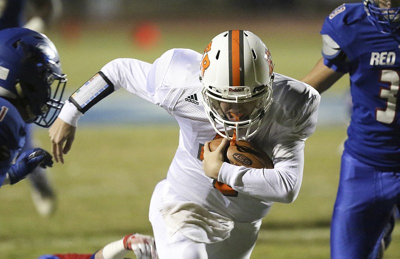 Staff Photo by Dan Henry / The Chattanooga Times Free Press- 11/11/16. Red Bank High School defenders close in on East Ridge High School quarterback Eric Bennett (7) during the first half of play at the Lion's home field on November 11, 2016. 