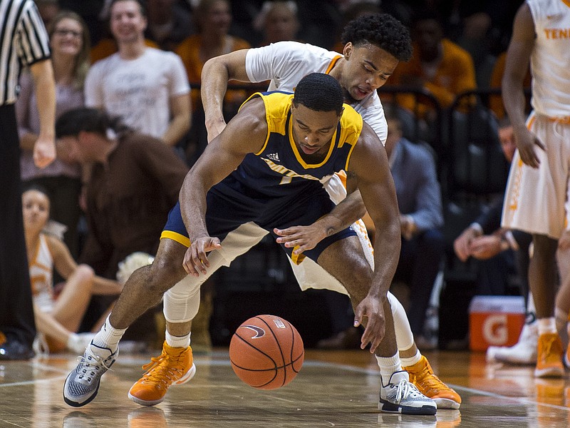 Tennessee's Lamonte Turner (1) tries to snatch the ball away from Chattanooga's Greg Pryor (1) during the first half against Chattanooga at Thompson-Boling Arena on Friday, Nov. 11 2016. 