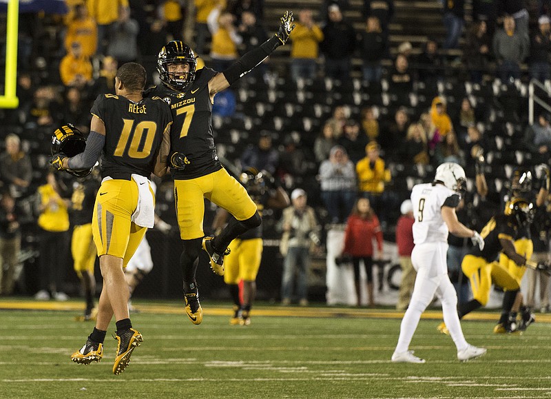 Missouri's Jason Reese, left, celebrates with teammate Cam Hilton as Vanderbilt's Caleb Scott, right, walks off the field after Vanderbilt turned the ball over on downs in the final two minutes of an NCAA college football game Saturday, Nov. 12, 2016, in Columbia, Mo. (AP Photo/L.G. Patterson)