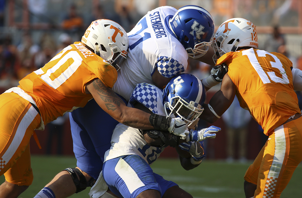 Tennessee's Cortez McDowell (20) and Malik Foreman (13) bring down Kentucky's Stanley