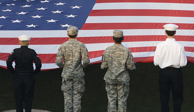 JROTC students representing various branches of the military hold an American flag at halftime during the Mocs' home football game against the Wofford Terriers at Finely Stadium on Saturday, Nov. 12, 2016, in Chattanooga, Tenn.