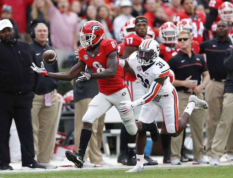 Georgia wide receiver Riley Ridley (8) makes a one-handed catch as Auburn defensive back Javaris Davis (31) defends in he first half of an NCAA college football game Saturday, Nov. 12, 2016, in Athens, Ga. (AP Photo/John Bazemore)