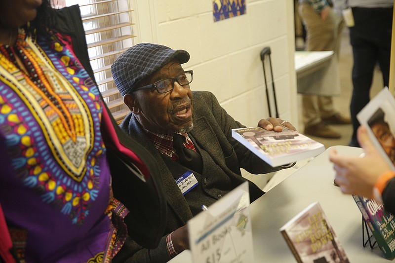 Author John M. Perkins signs books for guests at a weekend conference on poverty and the church at New City Fellowship on Saturday, Nov. 12, 2016, in Chattanooga, Tenn. The conference, hosted by the United Way and Chalmer Center at Covenant College, was aimed at educating local churches on understanding and alleviating poverty.