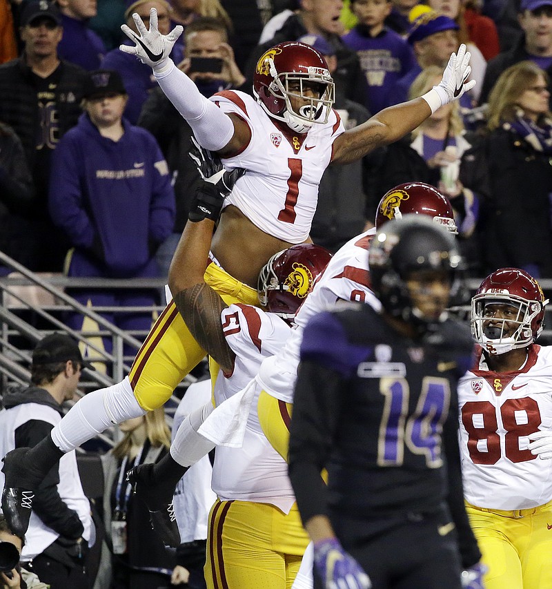 
              Southern California's Darreus Rogers (1) celebrates his touchdown against Washington in the first half of an NCAA college football game Saturday, Nov. 12, 2016, in Seattle. (AP Photo/Elaine Thompson)
            