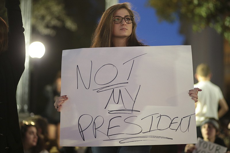 Anna Thornton participates in an anti-Donald Trump election protest downtown Athens, Ga. Wednesday. "I fear we're going to lose all of the rights we've gained when Trump takes office," said Thornton. (John Roark/Athens Banner-Herald via AP)