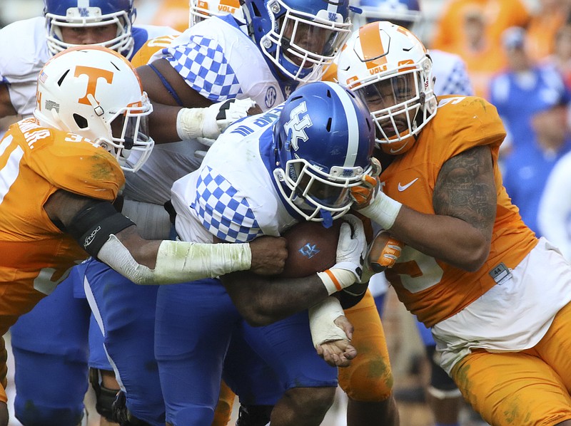 Staff Photo by Dan Henry / The Chattanooga Times Free Press- 11/12/16. Tennessee's Darrin Kirkland Jr. (34) and Derek Barnett (9) collide with Kentucky's William Mahone III (32) during the fourth quarter of play. The Tennessee Volunteers won over the Kentucky Wildcats with a final score of 49-36 at Neyland Stadium in Knoxville, Tenn., on Saturday, November 12, 2016. 