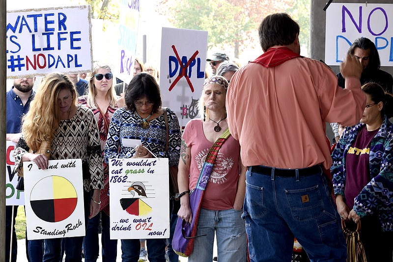 Protesters are lead in prayer by the Rev. Brian Merritt prior to the start of the marchThe Chattanooga Solidarity March for Standing Rock started at Renaissance Park and continued to 4th street before returning to Park on November 13, 2016 .  The march was to support the opposition to the building a oil pipeline through the Stand Rock Indian Reservation in South and North Dakota.  