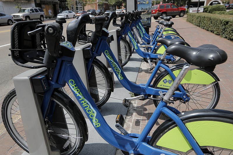 A row of Chattanooga Bike Share bicycles is seen at a stand on Market Street on Thursday, July 30, 2015, in Chattanooga, Tenn. The program is offering $5 monthly memberships.