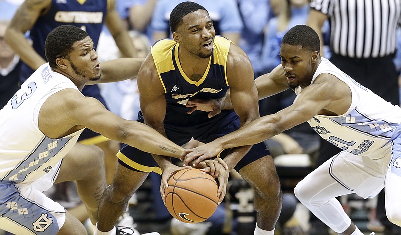 North Carolina's Kennedy Meeks (3) and Seventh Woods, right, reach for the ball against Chattanooga's Greg Pryor during the first half of an NCAA college basketball game in Chapel Hill, N.C., Sunday, Nov. 13, 2016. North Carolina won 97-57. (AP Photo/Gerry Broome)