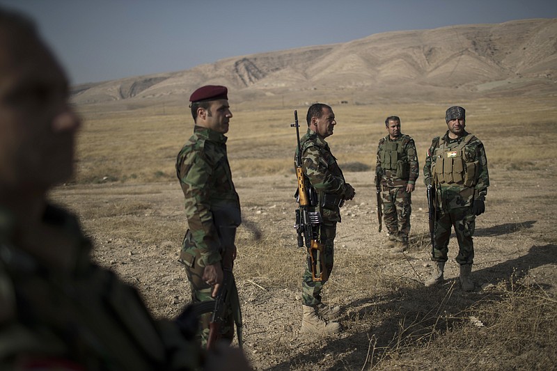 
              FILE - In this Tuesday, Nov. 8, 2016, file photo, Kurdish Peshmerga fighters gather near a frontline during fighting with Islamic State militants in Bashiqa, east of Mosul, Iraq. Human Rights Watch is accusing the security forces of Iraq's regional Kurdish government of destroying Arab homes and even some villages in areas retaken from the Islamic State group. (AP Photo/Felipe Dana, File)
            