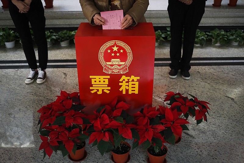 
              A woman casts her ballot for representatives to the local district assembly known as the people's congress at a polling station set up in a residential building in Beijing, Tuesday, Nov. 15, 2016. Chinese authorities have responded to a small but determined group of independent candidates running in district elections with round-the-clock surveillance and confinement aimed at obstructing their efforts to build support. The controls reflect the ruling party's determination to maintain a rock-solid hold on politics at all levels, galvanized in recent years by President Xi Jinping's steady accumulation of political authority that has made him the most powerful Chinese leader since the 1980s. (AP Photo/Andy Wong)
            