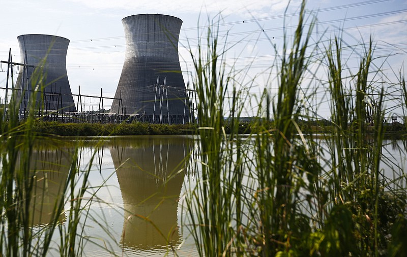 
              FILE - In this Wednesday, Sept. 7, 2016 file photo, two cooling towers can be seen in the reflection of a pond outside of the Bellefonte Nuclear Plant, in Hollywood, Ala. The Tennessee Valley Authority has sold the unfinished nuclear power plant for $111 million. Nuclear Holdings LLC purchased the Bellefonte Nuclear Plant at an auction Monday, Nov. 14, 2016. The sale price was more than three times the minimum bid of $36.4 million. (AP Photo/Brynn Anderson, File)
            