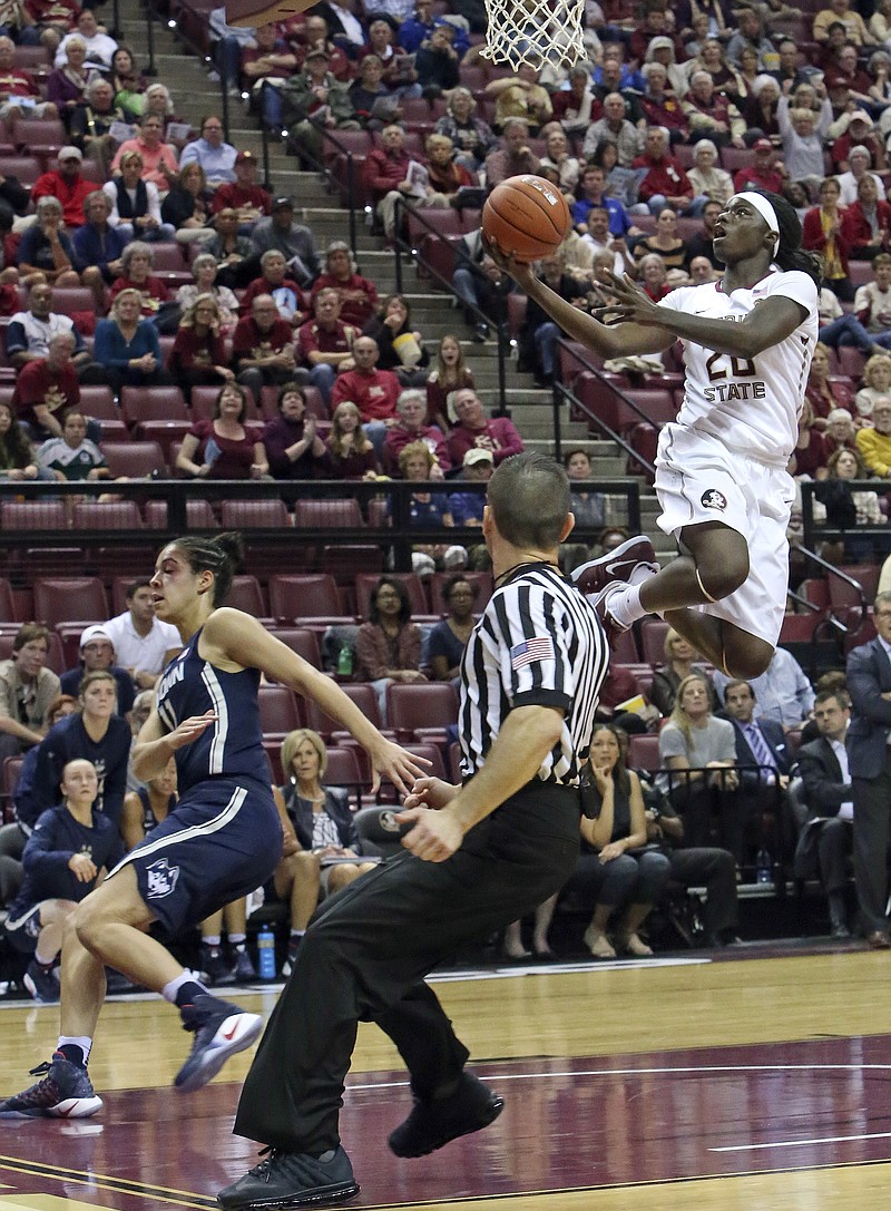 
              Florida State's Shakayla Thomas scores on a break away against Connecticut's Kia Nurse in the first quarter of an NCAA college basketball game Monday, Nov. 14, 2016, in Tallahassee, Fla. (AP Photo/Steve Cannon)
            