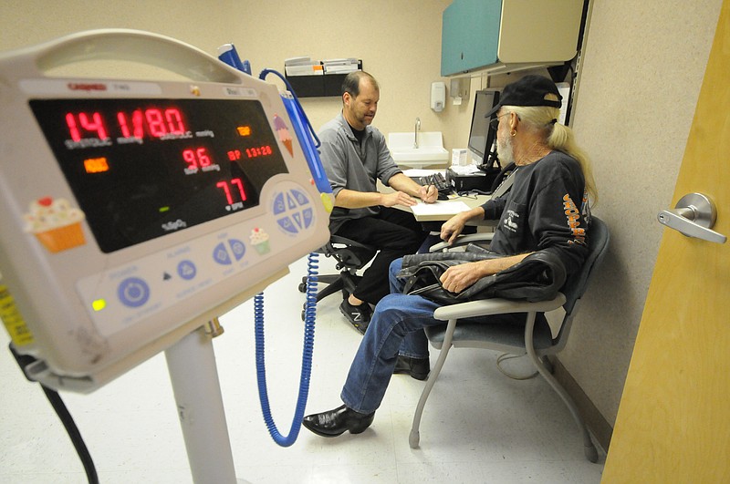 A nurse, left, attends to a Vietnam and Desert Storm veteran at the Chattanooga Veterans Affairs Clinic at Eastgate Town Center.