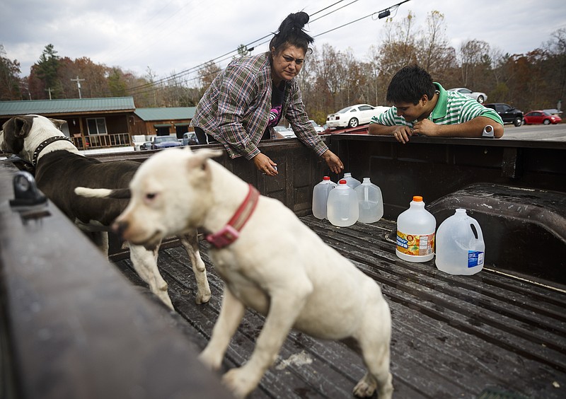 Stephen Burnside, right, and his mother Izzy put bottles of water in the bed of their pickup truck after having them filled at the Luminary Frostbite Volunteer Fire Department on Tuesday, Nov. 15, 2016, in Luminary, Tenn. Burnside said that while their well water has not completely stopped running, it has turned brown. The ongoing severe drought in the region has caused many wells, the primary source of water in the Luminary community, to run dry. TEMA has begun providing water for pickup at the volunteer fire department, and area churches and businesses along with Dayton and Dunlap have also donated water.