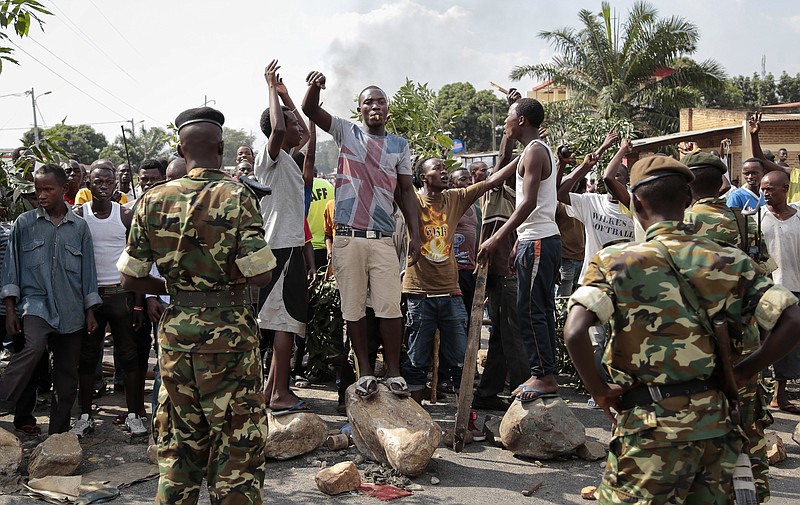 
              FILE - In this May 27, 2015 file photo, opposition demonstrators confront army soldiers in the Mutarakura district, as security forces try to prevent people moving out of their neighborhoods, in the capital Bujumbura, Burundi. A global human rights umbrella organization issued a report on Tuesday, Nov. 15, 2016, urging Africa, Europe and the United Nations to send a civilian protection force to Burundi to prevent a possible civil war and genocide. (AP Photo/Gildas Ngingo, File)
            