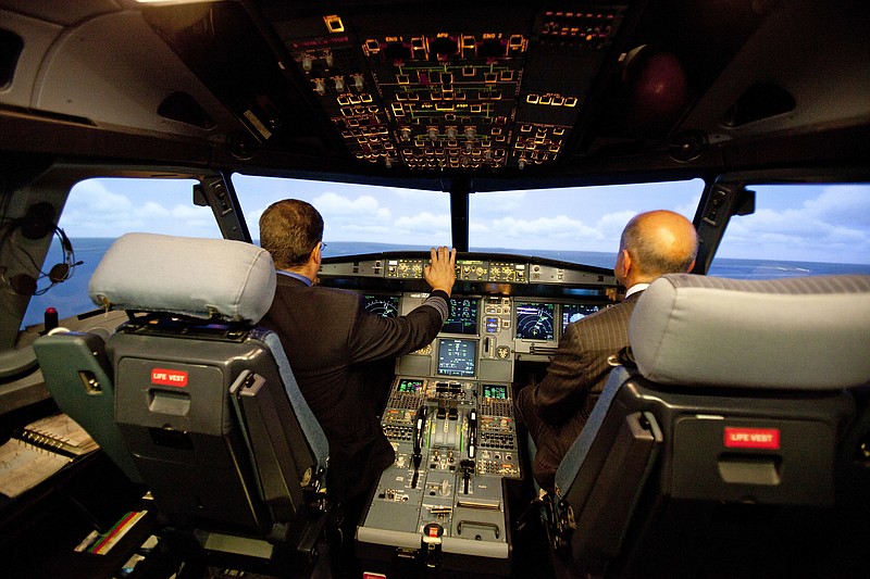 
              FILE - In this Sept. 20, 2012, file photo, Jet Blue pilot, Captain Joe Devito, left, navigates a NextGen flight simulator with FAA Administrator Michael Huerta at a Jet Blue facility in Orlando, Fla. The Federal Aviation Administration has little to show for a decade of work on modernizing air traffic control, and faces barriers and billions more in spending to realize its full benefits, says a report released Nov. 15, 2016, by a government watchdog. (AP Photo/John Raoux, File)
            