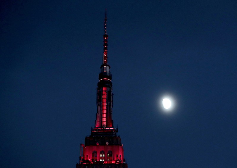 
              FILE - In this Thursday, Nov. 10, 2016, file photo, the moon is seen in its waxing gibbous stage as it rises near the Empire State Building, in New York. On Tuesday, Nov. 15, 2016, the Federal Reserve Bank of New York issues its Empire State manufacturing index for November. (AP Photo/Julio Cortez, File)
            