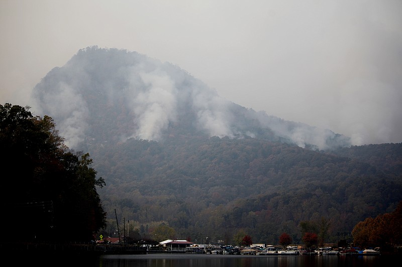 
              In a Saturday, Nov. 12, 2016 photo, smoke billows from the Party Rock fire in Lake Lure, NC. North Carolina Gov. Pat McCrory on Monday, Nov. 14, planned to update residents on wildfires in western North Carolina as officials report some progress in containing the blazes. (Angela Wilhelm/The Asheville Citizen-Times via AP)
            