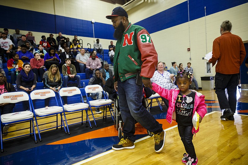 Michael Brown, Sr., walks in with his daughter, Mikelle Brown, before speaking to students and faculty on the campus of Chattanooga State Technical Community College on Wednesday, Nov. 16, 2016, in Chattanooga, Tenn. Brown is the father of Michael Brown, Jr., who was fatally shot by a white police officer in Ferguson, Mo., in 2014.