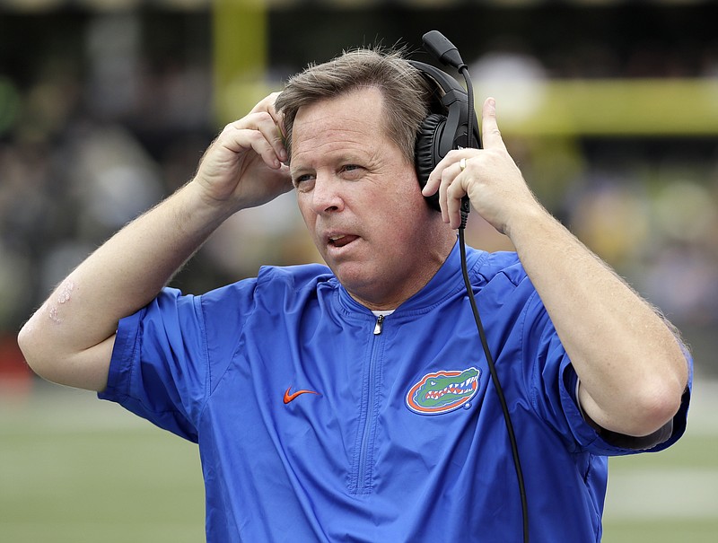 FILE - In this Oct. 1, 2016, file photo, Florida head coach Jim McElwain watches from the sideline in the second half of an NCAA college football game against Vanderbilt in Nashville, Tenn. Georgia head coach Kirby Smart and McElwain become close friends while spending four years together at Alabama (2008-11) and will reunite for a game Saturday, Oct. 29, 2016. (AP Photo/Mark Humphrey, File)