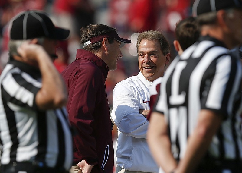 Alabama football coach Nick Saban, right, shares a laugh with Mississippi State coach Dan Mullen before Saban's Crimson Tide routed Mullen's Bulldogs last Saturday in Tuscaloosa, Ala.