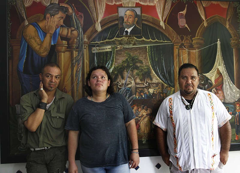 
              In this July 2, 2016 photo, Luis Edgardo Charnichart Ortega, left, Evanibaldo Larraga Galvan, center, and Juan Carlos Soni Bulos stand in Soni's terrace at his home, in Tanquian de Escobedo, San Luis Potosi, Mexico. The three men were detained by Mexican Marines, tortured and spent more than a year in prison on weapons and drug charges, without trial until a judge in March 2015 threw out the case. (AP Photo/Marco Ugarte)
            