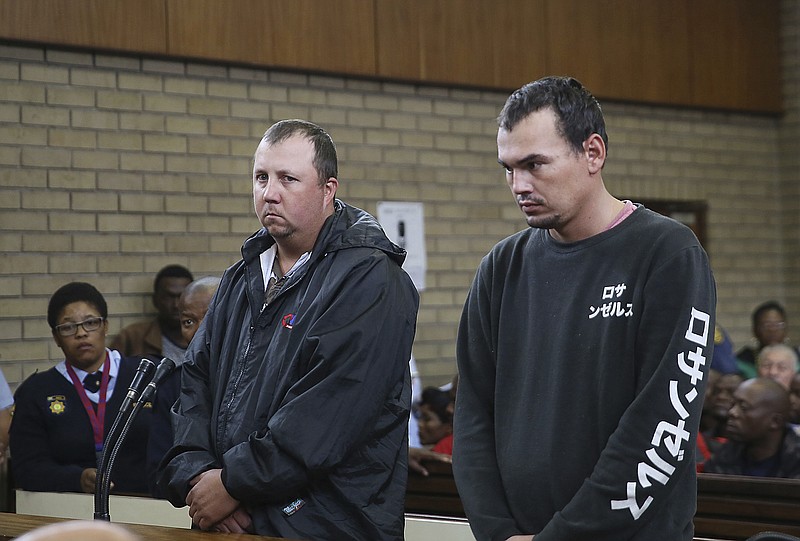 
              Theo Jackson, left, and Willem Oosthuizen, right, appear in the Magistrates Court in Middelburg, South Africa Wednesday, Nov. 16, 2016. Two white South Africans accused of forcing a black man into a coffin and threatening to set him on fire appeared before a judge on Wednesday as demonstrators protested against racism outside the courthouse. (AP Photo)
            