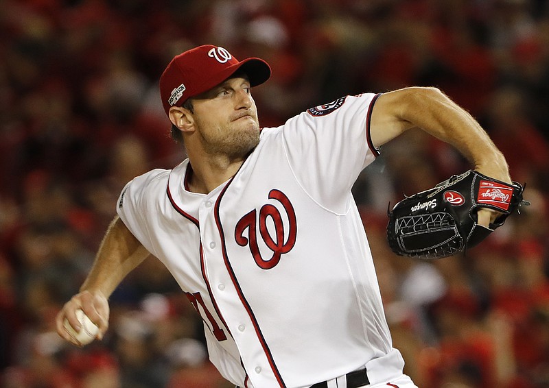 In this Oct. 13, 2016, file photo, Washington Nationals starting pitcher Max Scherzer winds up during the first inning in Game 5 of baseball's National League Division Series, against the Los Angeles Dodgers, in Washington. Scherzer, Kyle Hendricks and Jon Lester are competing for the National League Cy Young Award. (AP Photo/Pablo Martinez Monsivais, File)